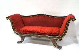 A Regency mahogany scroll frame chaise longue with gilt detail, on brass lion's paw feet,