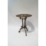 A Victorian cast iron pub table, on scroll legs with Griffin heads,