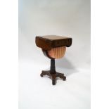 A William IV rosewood work table on carved column and quatreform base,