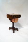 A William IV rosewood work table on carved column and quatreform base,