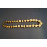 A graduated row of late Victorian ivory beads