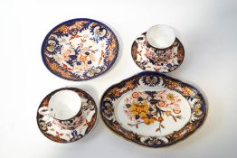 A pair of Royal Crown Derby teacups and saucers, in the Imari palette,