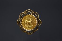A one tenth Krugerand coin, in a 9 carat gold ring mount, finger size L1/2, 6.