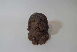 A 19th century Black Forest inkwell, carved as a shaggy dog, with brass liner,