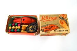 A Schuco Telesteering car, with steering wheel, wooden ball, obstacles, wire and winding key,