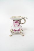 A Dresden porcelain candlestick, decorated with garlands of roses and gilt detail,