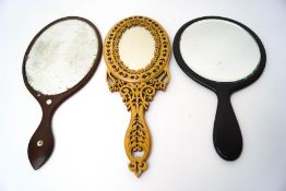 An Italian olivewood(?) hand mirror with inlaid flower and carved decoration,