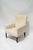 An early 20th century armchair with cream linen upholstery, on turned legs,