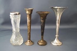 A collection of three silver posy vases; another stamped 'Sterling';