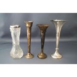 A collection of three silver posy vases; another stamped 'Sterling';