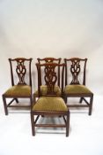 A set of four 19th century mahogany dining chairs, with pierced splats and scroll detail,