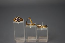 A 9 carat gold wishbone ring; and a 9 carat gold synthetic stone cluster ring; 4.