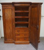 A Victorian mahogany breakfront triple wardrobe with one mirrored door opening to reveal four