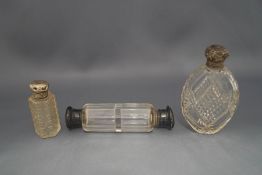 A collection of three clear glass scent bottles,