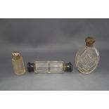 A collection of three clear glass scent bottles,