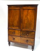 A Victorian mahogany linen press, upon a three drawer base,