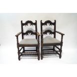 A pair of 19th century oak armchairs in the Derbyshire style, with carved back and crest rails,