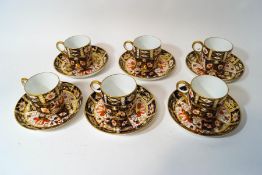A set of six Royal Crown Derby coffee cups and saucers, in the Imari pattern,
