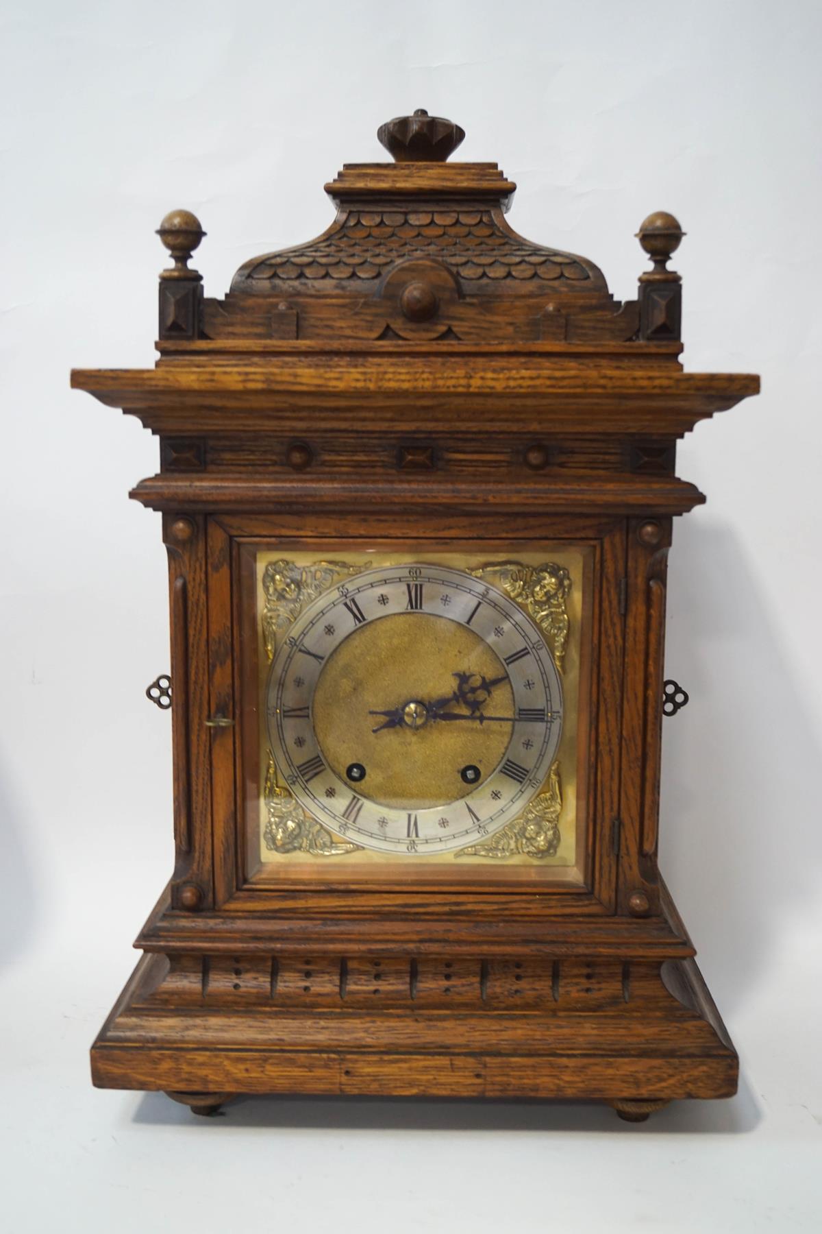 A late Victorian carved oak cased mantel clock, the eight day movement by Winterhalder & Hofmeier,