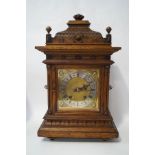 A late Victorian carved oak cased mantel clock, the eight day movement by Winterhalder & Hofmeier,