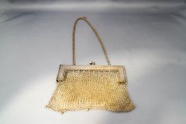A mesh purse, the frame with flowers and foliate scrolls and marked 'German Silver',