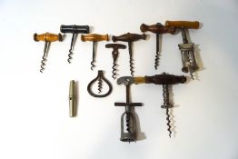 A collection of eleven corkscrews including a folding example and a travelling corkscrew which also