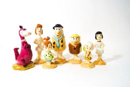 A Beswick set of seven Flintstone figures: Fred Flintstone, Wilma Flintstone, Pebbles Flintstone,