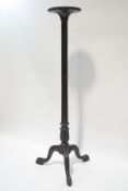 A William IV mahogany torchere, carved reeded column upon acanthus leaf base and claw feet,