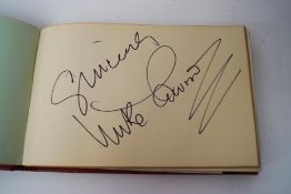 An Autograph book containing those of The Seekers, The Batchelors, Cliff Richard, and others,