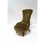 A Victorian mahogany button back chair on turned and carved legs