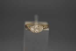 A four stone diamond ring, stamped '18ct', with pairs of single cuts to the shoulders,