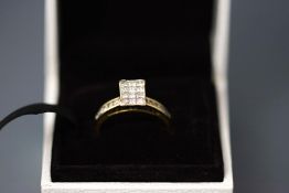 An 18 carat gold diamond ring, the rectangular head set with twelve Princess cut stones,