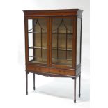 An Edwardian mahogany display cabinet with boxwood stringing, upon square tapering legs,