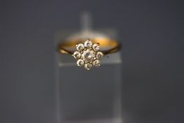 A 9 carat gold cubic zirconia flowerhead cluster ring, finger size N1/2, 1.