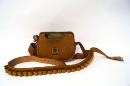 A tan leather gun cartridge bag,