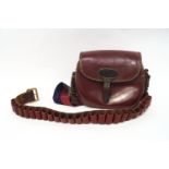 A maroon red leather gun cartridge bag,