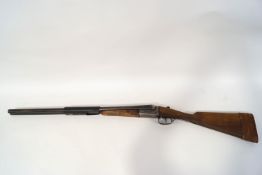 An AYA 12 gauge side by side shot gun,