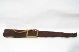 A gun carrying slip with sheepskin lining and smooth leather face, canvas straps and zip fastening,
