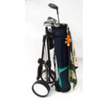 A golf trolley and clubs