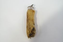 A silver mounted fox paw