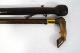 Two walking sticks, the handle of one modelled as a horse hoof,