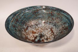 A 20th century Studio glass bowl with rust brown lacework pattern against a deep blue ground,