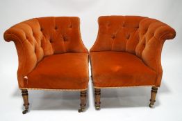 A pair of Victorian button back corner chairs on turned mahogany legs and brass casters,