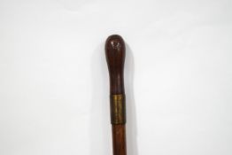 An early 20th century swordstick with turned wooden handle, the blade stamped Wilkinson,