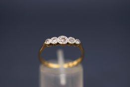 A five stone diamond ring, stamped '18ct Plat', the graduated single cuts illusion set,