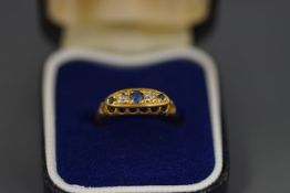 An 18 carat gold five stone sapphire and diamond ring, stamped '18ct', finger size J, 3.