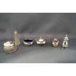 A three piece silver cruet set with two silver spoons and plastic liners; a silver crested saucepan;