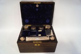 A Victorian coromandel ladies dressing case, containing silver plated topped glass jars,
