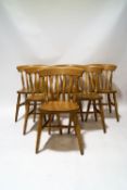 A set of six pine stickback chairs with solid seats and turned legs