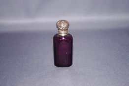 An amethyst glass scent bottle, with an unmarked embossed hinged cover, with stopper, 6.
